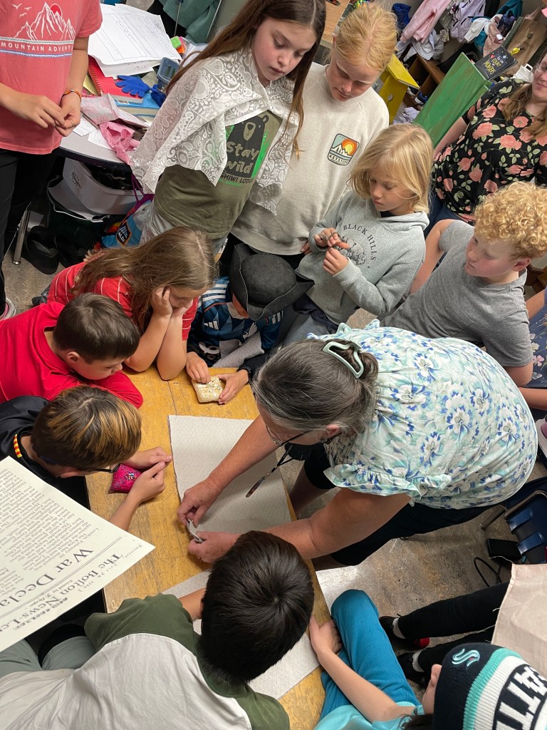 Children gathered around teacher
