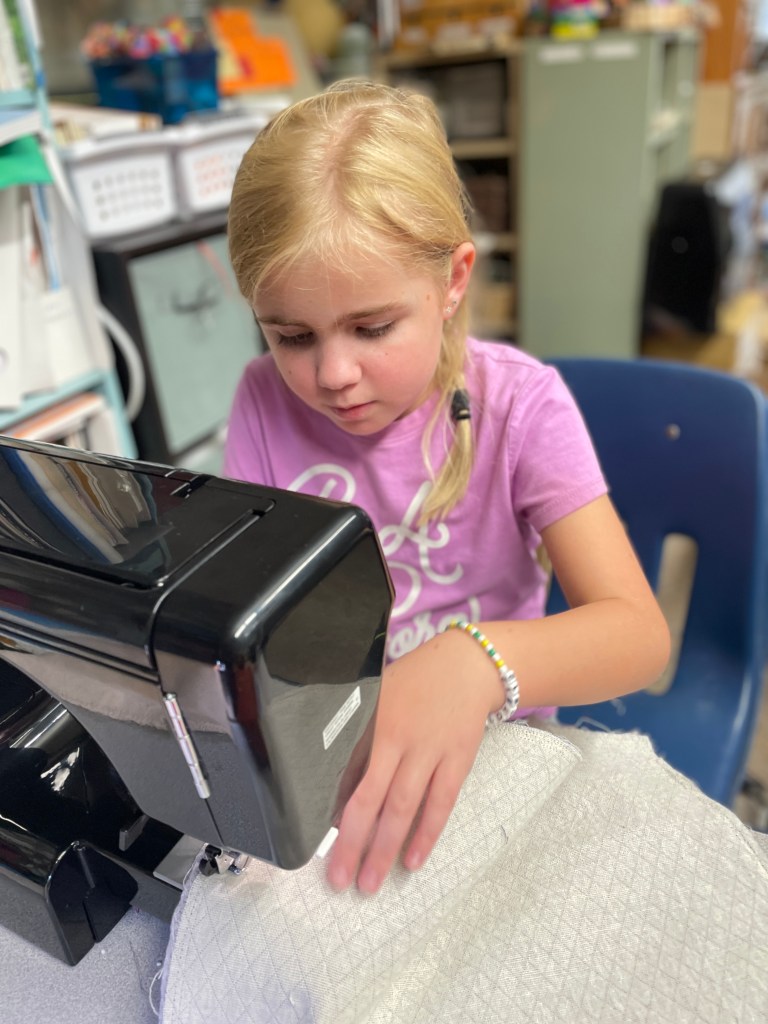 Child at sewing machine