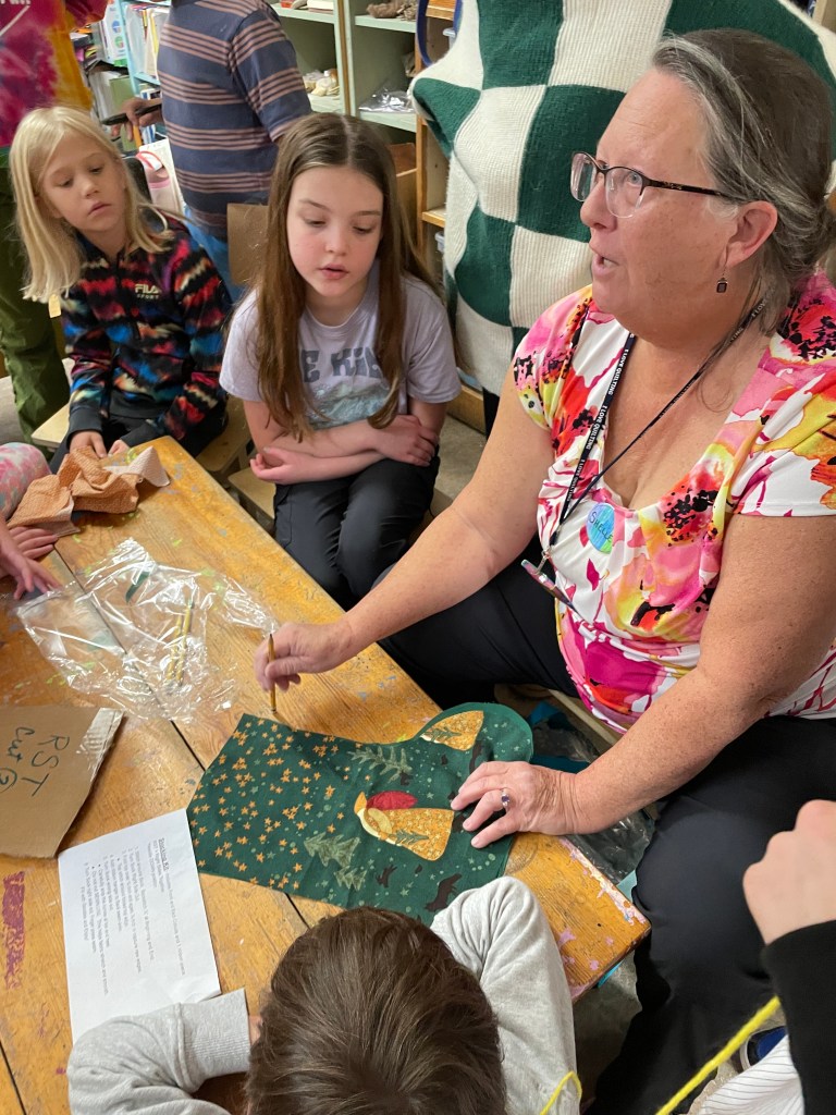 Teacher showing students how to pin project
